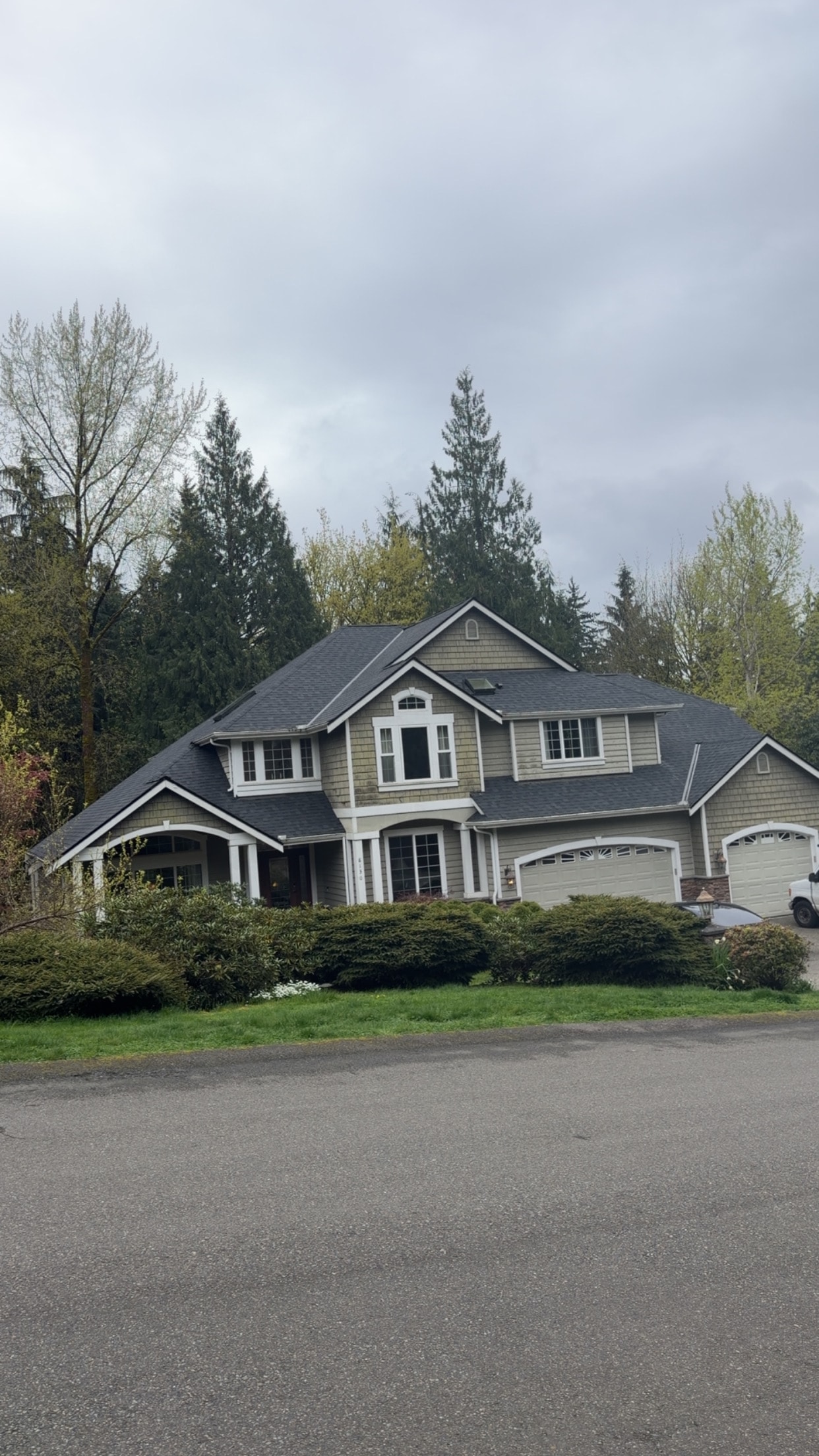 Completed two-story residential home with dark architectural shingles after full roof replacement